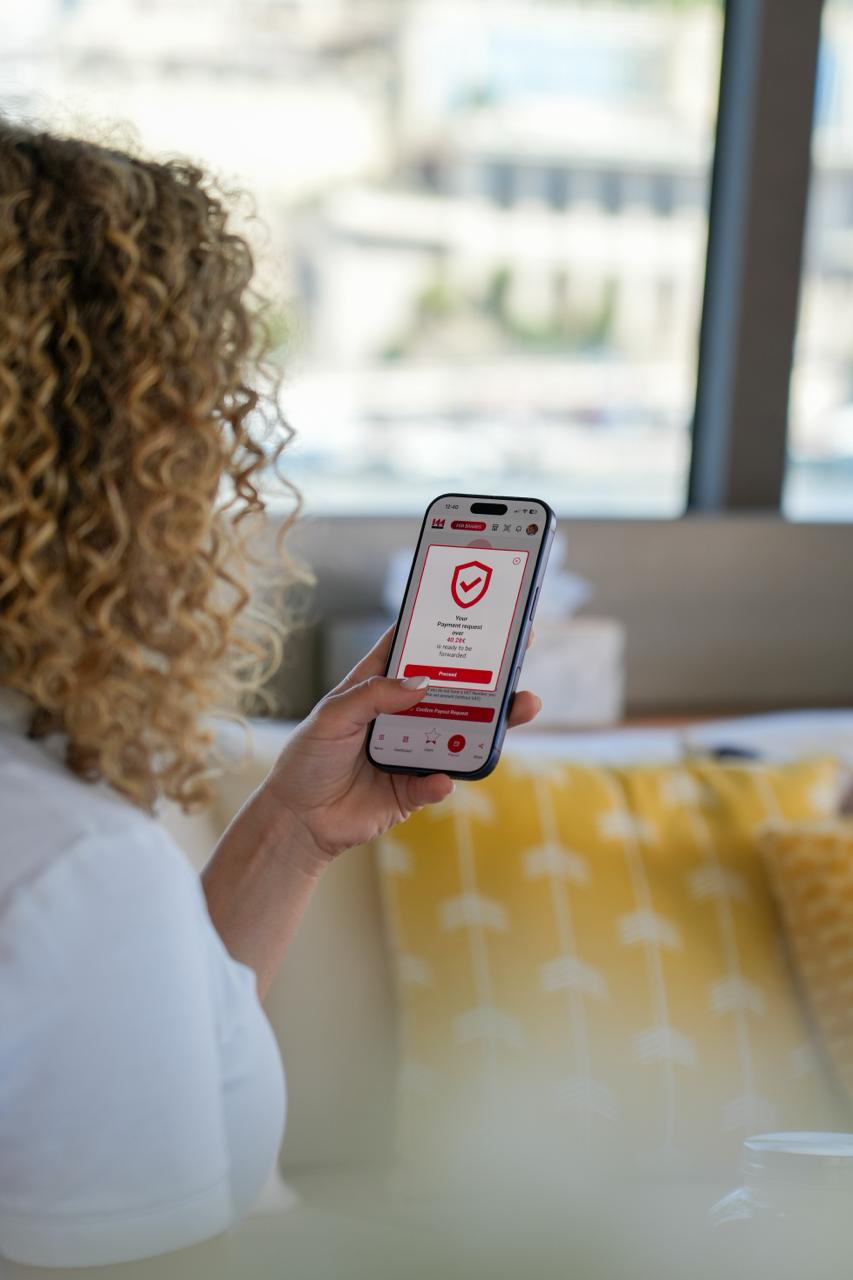 Person holding a phone showing a Monamedia payout request